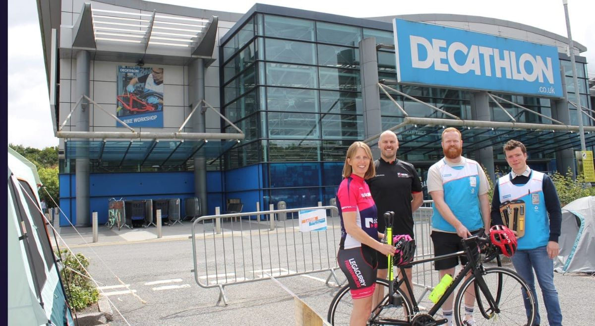 Claire Henderson and Philip McKelvey from SERC with Matthew Ferguson and Lee Aston, of Decathlon outside a Decathlon shop